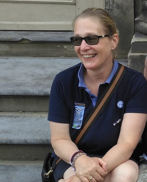 a woman in Girlguiding uniform sitting on some stone steps
